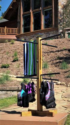 two backpacks are hanging on a rack in front of a house