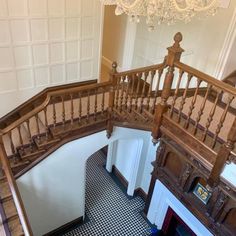 an overhead view of a staircase with black and white checkered flooring