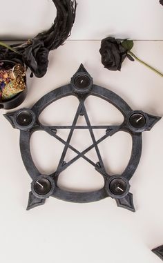 Bring druidess vibes to your altar and dining table. This stone look pentagram has space for tealights at each point as well as holes for stick incense, cast in soft curves resembling the hands of a clock. A wonderful centrepiece for any table needing the soft glow of a warm candle. Each holder comes with 5 tealights and 3 incense sticks as shown. Cast resin. Measures: 40cm Pagan Candle Holder, Pentagram Herb Hanger, Clay Art Crystal Holder, Pentagram Candle, Gothic Lifestyle, Tea Lights Centerpieces, Warm Candle, Masquerade Invitations, Alternative Home Decor