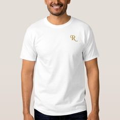 a man wearing a white t - shirt with the letter r in gold on it