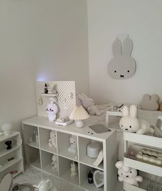 there are many stuffed animals on the shelves in this child's room, including teddy bears and other toys