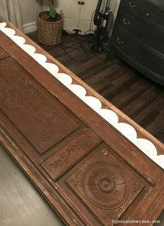 an old wooden bed frame with white trim