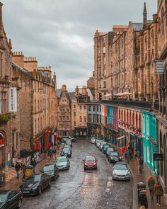 cars are parked on the street in front of buildings