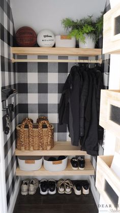 a black and white checkered closet with baskets, shoes and coats on the shelves