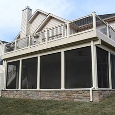 a large white house with lots of windows and balconies on the top floor