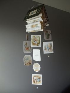 there are many plates hanging on the wall with magnets attached to it and pictures hung above them