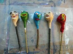 five different colored toothpicks with faces on them