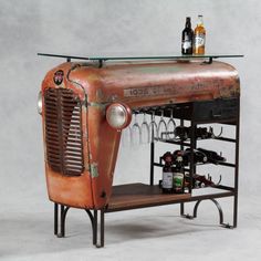 an old fashioned bar with wine glasses and bottles on the top, sitting in front of a gray background