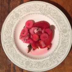 a white plate topped with sliced up tomatoes