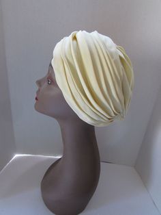 "SALE! 10% OFF! Attractive pleated turban in sunny yellow. The fabric is silky, a rayon?  The pleats run horizontal at the front and vertical at the back panel. It carries a Marshall Field & Company Millinery label which helps us date this to before 2005. It also carries a union label. One may want to play with the pleats to fold as one wants. This is a deaccession item from a small Midwestern museum Size: 13\" front to back and side to side; 22\" inner band circumference Condition: very good-no Fitted Yellow Turban, Great Gatsby Accessories, Vintage Turban, Spring Hats, Turban Headwrap, Turban Hat, Vintage Hats, Church Hats, Pink Spring