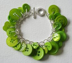 a green bracelet with lots of buttons on it