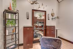 the inside of a hair salon with lots of shelves and mirrors on the wall above it