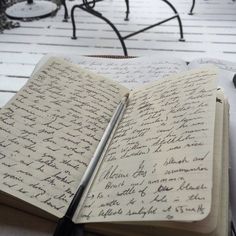 an open notebook sitting on top of a wooden table