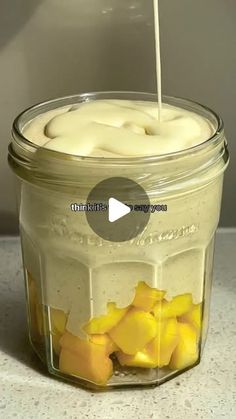 a jar filled with yellow flowers sitting on top of a table