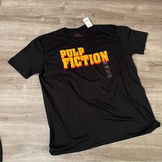 Black T-Shirt Says “Pulp Fiction” In Gold And Red Unisex Nwt/New With Tags Pulp Fiction Shirt, Gold And Red, Pulp Fiction, Black T Shirt, Black Tshirt, Graphic Tee, Shirt Designs, Jumper, Graphic Tees