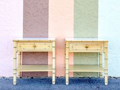 two wooden tables sitting next to each other in front of a pink and blue wall