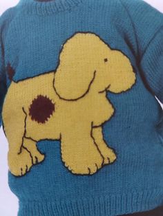 a child wearing a blue sweater with a yellow dog on it's chest and back