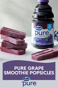 purple grape smoothie popsicles with blueberries and yogurt in the background