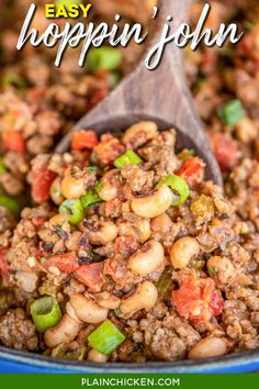 a wooden spoon filled with beans and meat