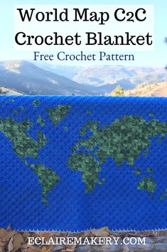 the world map crochet blanket is shown with mountains in the background