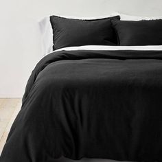 a black and white photo of a bed with two pillows