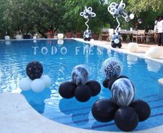 balloons floating in the water near an outdoor pool with words to do fest written on it