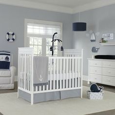 a baby's room is decorated in blue and white