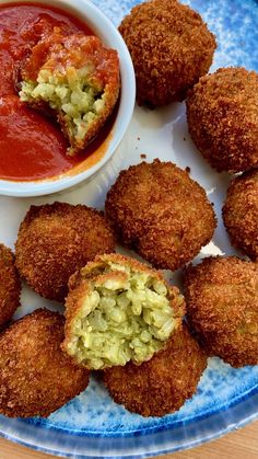 some fried food is on a plate with sauce and dipping sauce in the bowl next to it