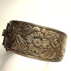 "Lovely one-inch wide-hinged brass bangle bracelet. The floral design is quite ornate and it scrolls around the entire circumference. There are no marks or hallmarks. It has a 6.5 to 7\" circumference.  Please Note ~ As vintage items are previously loved /used, please expect minor wear like surface wear /dents /dings and metal discoloration.   Please take time to view all photos and zoom in on the pictures before purchasing!  If you need additional pictures message me and I will be happy to provide them. Thank you for browsing!" Luxury Bronze Brass Bracelets, Luxury Antique Etched Bangle, Brass Hinges, Brass Bangle, Forest Hills, 5 To 7, Hinged Bracelet, One Inch, Take Time