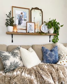 a living room filled with lots of furniture and decor on top of a shelf above a couch