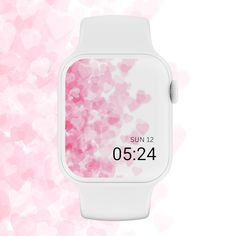 a white watch with pink hearts on the face and numbers displayed in front of it