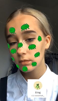 a girl with green frog stickers on her face