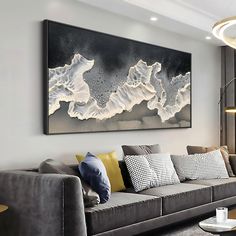 a living room filled with furniture and a large painting on the wall above it's couch