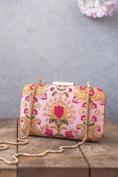 "Our Alanna clutch is detailed with thread and zari and sequin embroidery on soft silk. Pair this with a vibrant pink ensemble and watch it stand out as a statement accessory! Embroidered front and back. Dimensions (LxB): 8\"x4\" Handle length: 47\" Handle drop: 23\" Material: Embroidery pure silk, suede lining, golden metal clutch frame, golden metal sling. Features: metal lock closure, detachable metal sling." Ladies Purses Handbags Style, Hand Bags For Women, Pumpkin Patch Outfit, Potli Bag, Step By Step Crochet, Potli Bags, Designer Clutch, Pink Box, Box Clutch