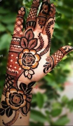 the hand is decorated with henna and flowers