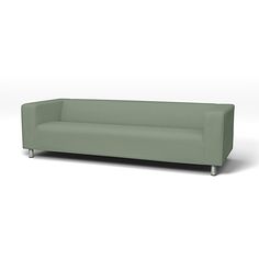 a green couch sitting on top of a white floor