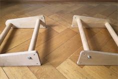 two wooden step stools sitting on top of a hard wood floor next to each other