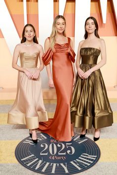 three women in dresses standing on the red carpet at the oscars 2019 awards ceremony