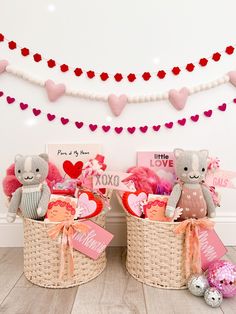 two teddy bears sitting in baskets with valentine's day decorations