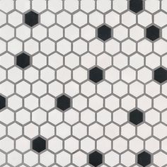 a white and black tiled wall with hexagonal tiles