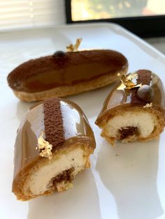 three desserts are sitting on a white plate