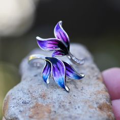 "I am no longer working with enamel so grab these while you can!! ( too many cheap copies of my work out there )- Hand Enameled - Colorful leaves, feather design  - 925 Sterling Silver - Cubic Zirconia This ring was made by first carving it in wax and then casting it. I usually make two at a time from one casting. This ring is really lovely, with a three dimensional leaf design that was enameled by hand. Since the enamel is done by hand each ring is a little bit different. If I don't have your size ready to go, get ahold of me. I don't always have the time but if I do, I will be happy to make it up for you in your size. This will come in a pretty gift box. Please note that I have only one of each size shown. Custom order sizes can be done as well. Please note custom sizes can take up to 8 Unique Enamel Flower Jewelry, Unique Enamel Flower Shaped Jewelry, Silver Flower Enamel Ring As A Gift, Hand Painted Enamel Jewelry For Anniversary, Nickel-free Purple Enamel Jewelry, Hand Painted Silver Flower Jewelry, Nickel-free Flower-shaped Enamel Jewelry, Silver Enamel Collectible Ring, Collectible Silver Enamel Ring