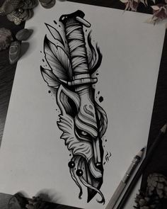 an ink drawing of a feather and dagger on paper with pencils next to it