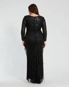 a woman in a long black dress with sequins on the sleeves and back