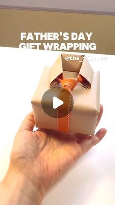 a person is holding a gift wrapped in brown paper with the words father's day give wrapping on it