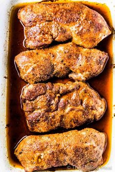 pork chops in a baking dish with sauce