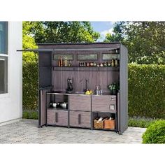 an outdoor storage shed with the door open and shelves full of bottles, cups and utensils