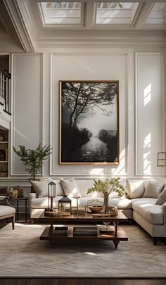 a living room filled with furniture and a painting hanging on the wall above it's coffee table