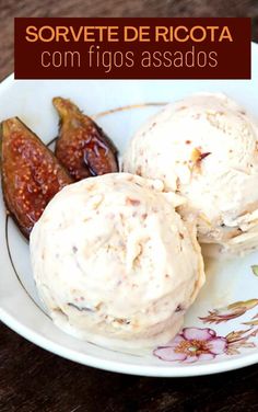 three scoops of ice cream sit on a plate with figs in the background