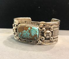 "Natural #8 Turquoise & sterling silver cuff, by highly regarded & collected Native American Indian, Wayne Aguilar of Santo Domingo Pueblo... with interesting sterling silver design work, including varied stamp work, depressed studs & really unusual front face hallmark stamp signed. Happy to get you more pics... please inquire. 7\" total interior circumference, with a 1 3/8\" gap... Can be opened up some, probably .5\". 398R - This stunning piece is coming from an exciting relationsh Feather Cuff Bracelet, Beaded Leather Wraps, Native American Bracelets, Womens Cuff Bracelets, Large Bracelet, Southwest Jewelry, Front Face, Turquoise Bracelet Cuff, Silver Design